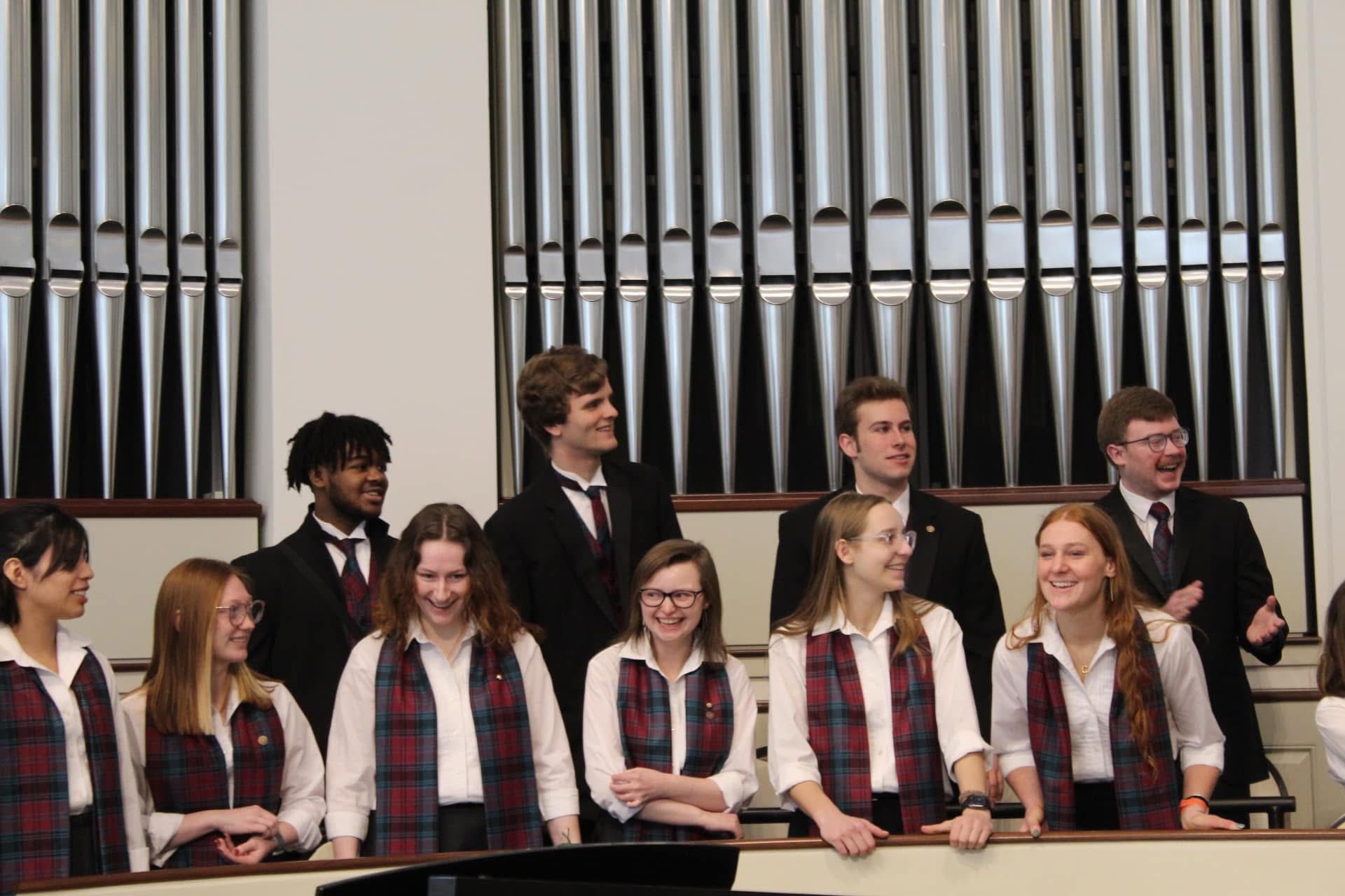 Alma_college_choir_2024 - Choir singers, dressed in alma colors ready to sing.