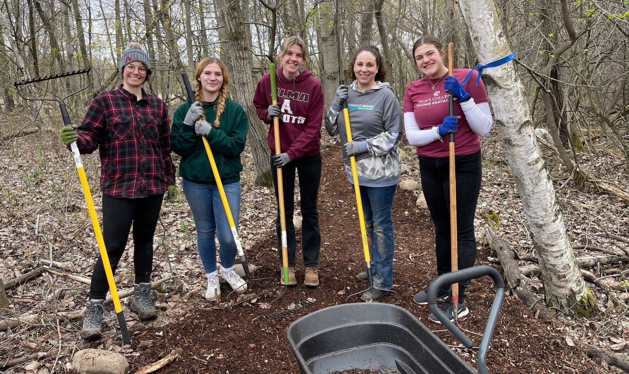 A group of students working out at Forest Hill Nature Preserve during an Alternative Break at Alma College.