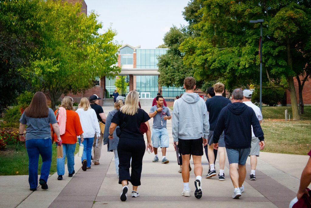Large group of students and parents visiting Alma College. 