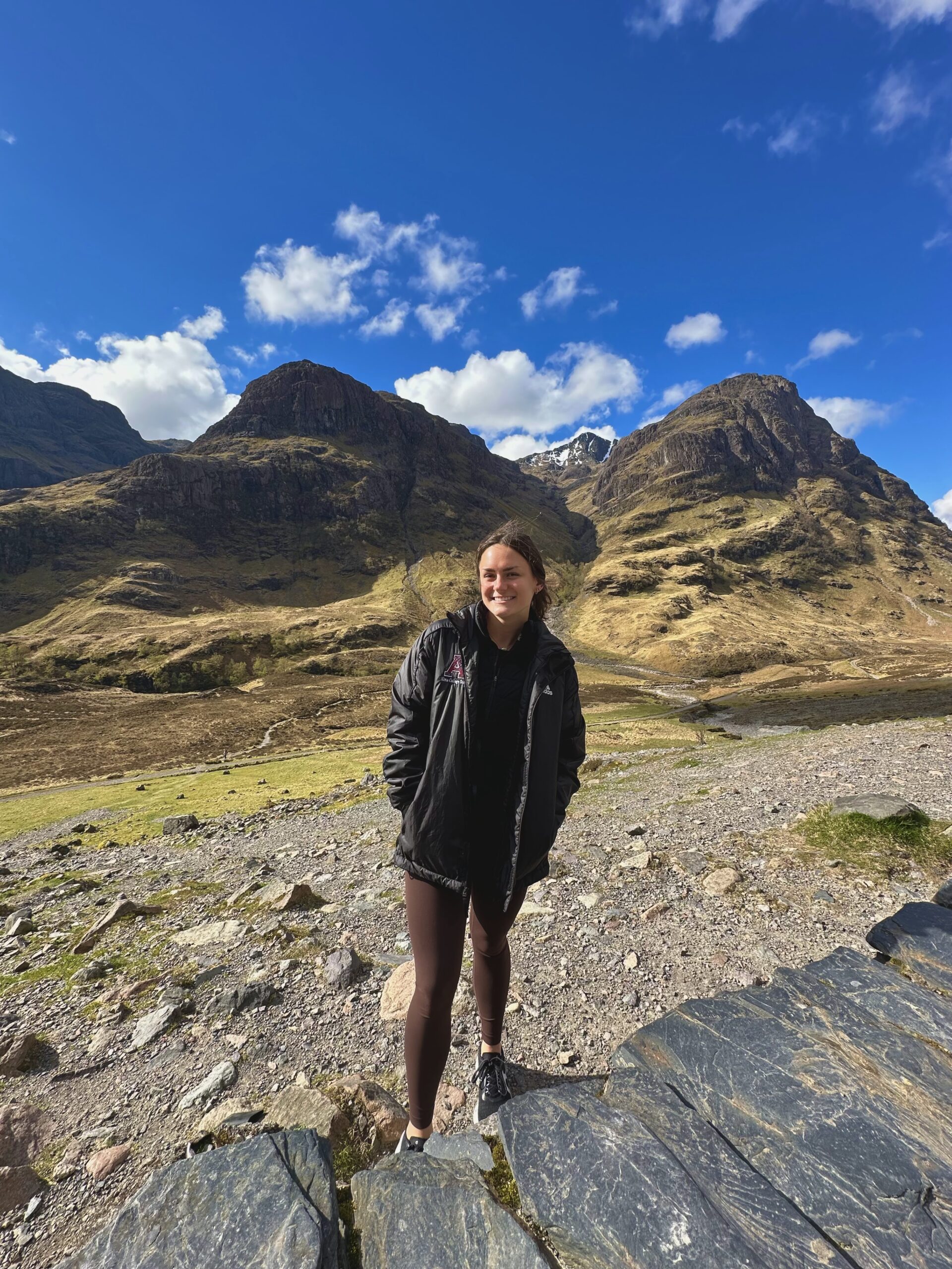 An Alma College Student stands in front of the Scottish mountains during her Spring Term.