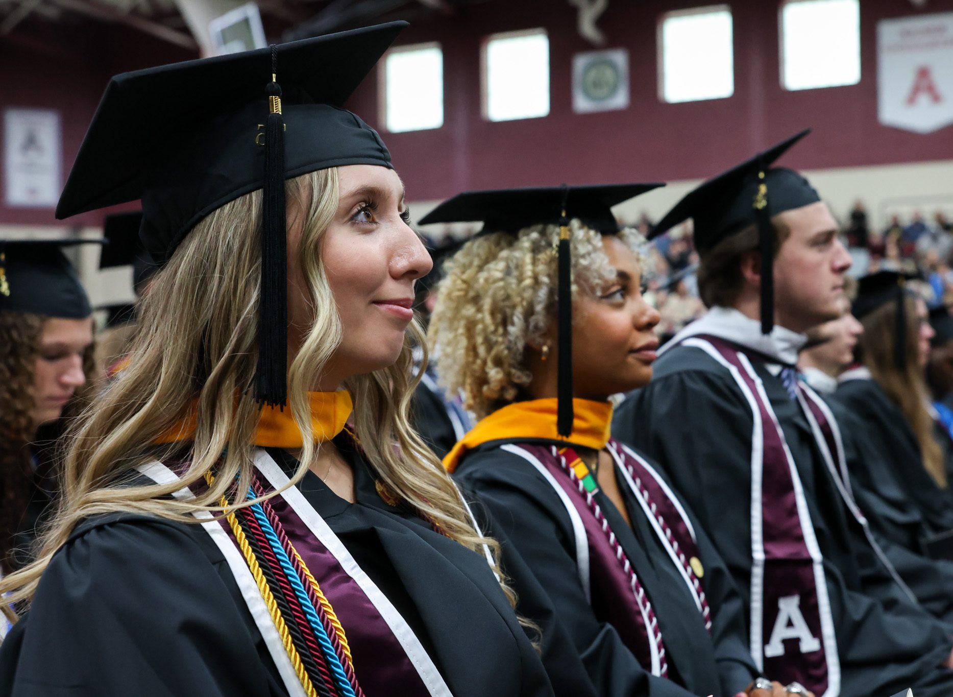 Graduating students intently listening to a speech at Alma College commencement ceremony 2026.