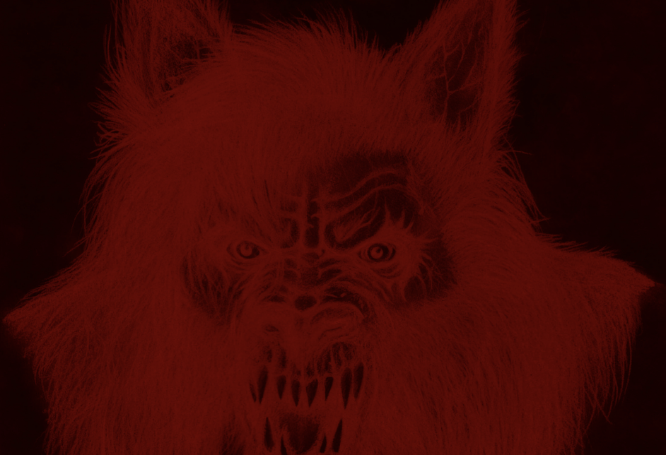 A snarling werewolf with sharp teeth and glowing eyes, its face and fur illuminated in dark red tones.