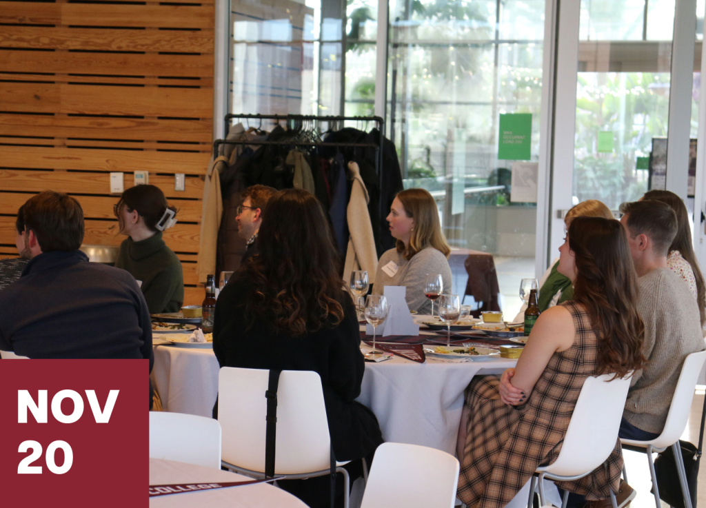 A group of people sit at a round table to connect and visit at an event, facing away from the camera, with a maroon graphic in the foreground that reads NOV 20.